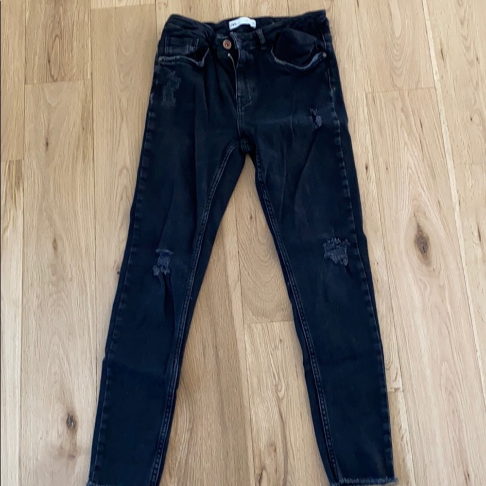 Black ripped jeans.